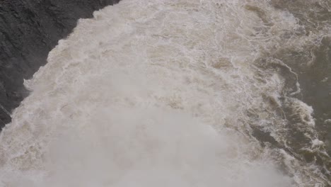 Handheld-shot-of-Hinze-Dam-turbulent-outflows-under-heavy-rain-during-La-Niña,-Gold-Coast-Hinterland,-Queensland,-Australia