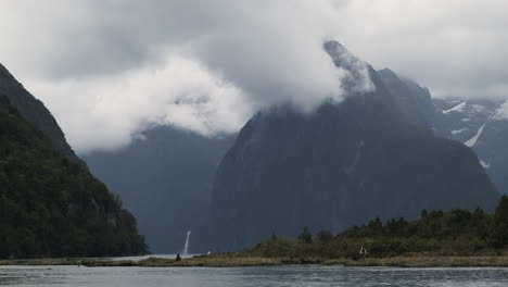A-stunning-view-of-the-epic-fjord-vista-of-Milford-Sound-with-a-waterfall-in-the-distance