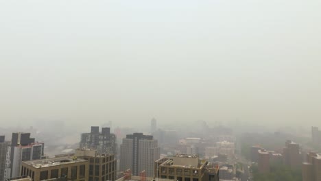Air-pollution,-toxic-bushfire-air-surrounding-condos-in-the-city-of-New-York,-USA---Aerial-view