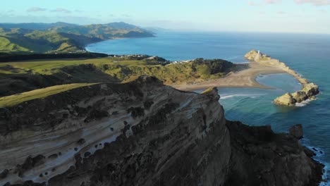 Person-Standing-On-Top-Of-Deliverance-Cove-Track-Overlooking-Beautiful-Castlepoint-Beach-And-Lighthouse-In-Wairarapa-Coast,-New-Zealand