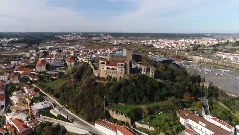 Drone-flight-reveals-layout-of-Leiria-city,-with-its-castle-in-center-Portugal