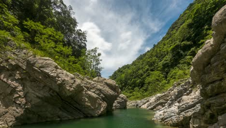 Adventure-tourists-dive-and-play-along-river-valley-cliffs-of-Rio-Nizao,-Charcos-de-Nizao,-Dominican-Republic---Timelapse