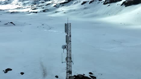 Critical-communication-infrastructure---Aerial-slowly-rotating-around-a-mast-filled-with-communication-equipment-for-cellphones-and-emergency-tetra-networks-and-more---Strynefjellet-Norway