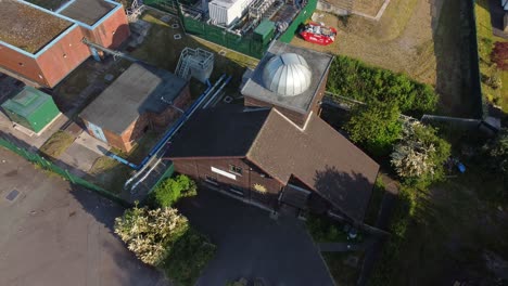 Aerial-view-looking-down-at-Pex-hill-Leighton-observatory-silver-dome-rooftop-on-hilltop-farmland-at-sunrise