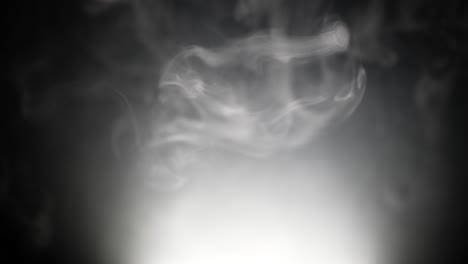 White-smoke-drifts-dreamily-down-through-atmosphere-air-in-wispy-strands-down-to-white-light