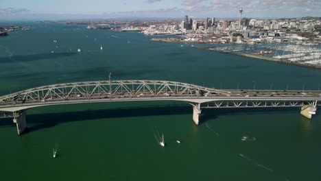 Aerial-tracking-of-traffic-on-Auckland-Harbour-Bridge,-most-important-transportation-connection-in-the-city