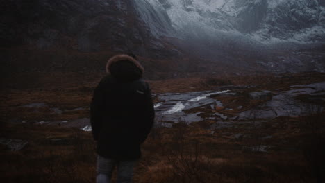 Lonely-traveller-hiking-in-wilderness,-Lofoten,-Norway,-rear-view