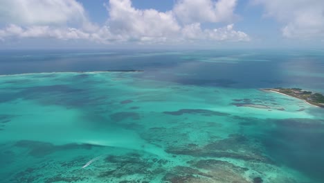 drone-shot-turn-around-Los-Roques-Archipelago,-coral-reef-and-shades-of-blues-caribbean-sea-water