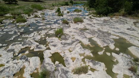 Aerial-flight-over-a-shallow-portion-of-the-Pedernales-River-in-Stonewall-Texas