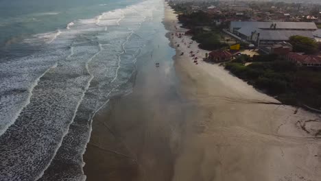 Aerial-tilt-shot-of-waves-and-beach-in-Brazil,-summer-time-ocean-view