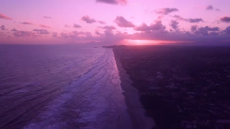 Beautiful-shot-of-pink-color-sky-and-waves-on-ocean-beach,-Itanhaem-Brazil