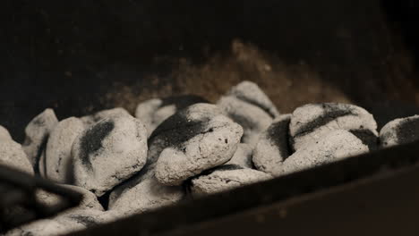 Charcoal-briquettes-becoming-covered-in-ash-in-Timelapse