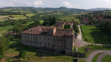 Castle-of-Agazzano-with-village-in-background,-Piacenza-province,-Italy