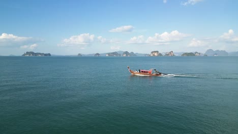 Traditional-Long-Tail-Boat-sailing-through-Thailand-Andaman-Sea-with-Limestone-Cliffs-Background,-Krabi-Phuket-Koh-Yao-Boat-Tour,-4-Island-Tour