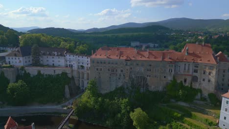 Best-aerial-top-view-flight-Krumlov-Cesky-castle-on-the-hill-castlein-in-czech-republic-in-Europe,-summer-of-2023