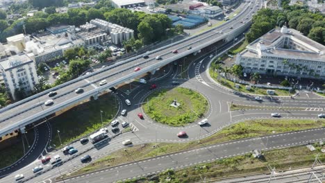 Aerial-view-of-busy-traffic-of-a-roundabout-in-Vacoas-Phoenix,-Mauritius