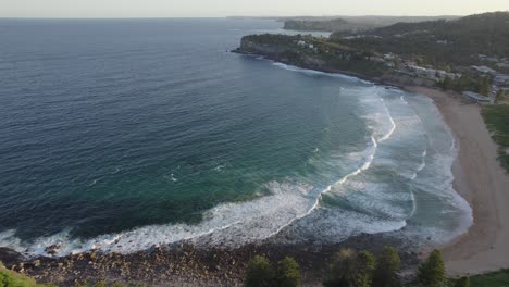 Foamy-Waves-Splashing-Sandy-Shore-At-Avalon-Beach-In-New-South-Wales,-Australia---aerial-drone-shot