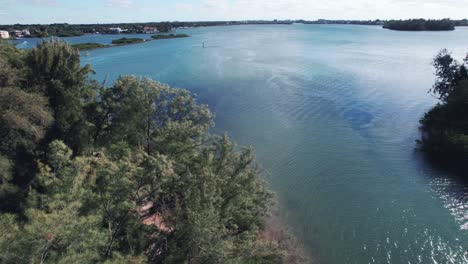 Drone-clip-over-blue-water-and-forested-areas-in-Gulf-of-Mexico,-near-Miami,-Florida