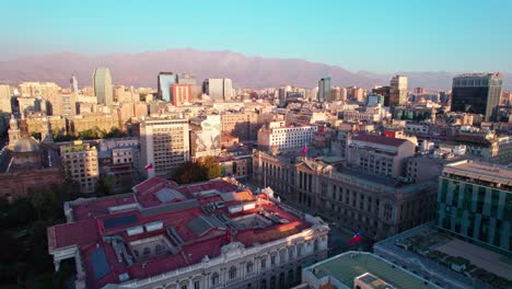 Establishing-aerial-view-flying-towards-Santiago,-Chile,-Chamber-of-Deputies-red-rooftop-historical-building
