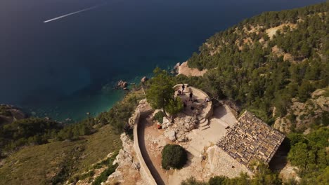 Orbit-drone-over-Ricardo-Roca-Viewpoint-steep-cliff-overseeing-blue-sea,-Spain