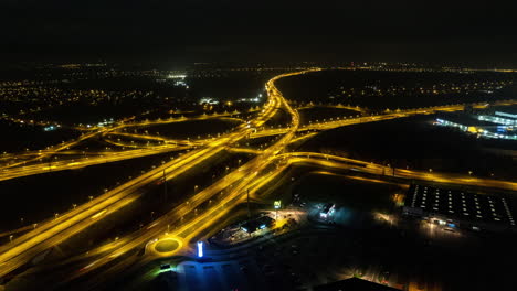 Aerial-drone-Hyperlapse-of-highway-intersection-at-night-with-cars-and-traffic