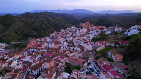 Aerial-dolly-in-over-picturesque-traditional-hilltop-village-in-Malaga-at-blue-hour