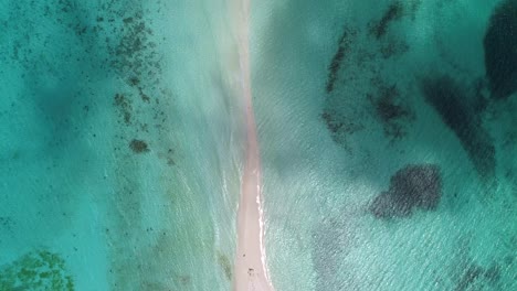 Aerial-top-down-view-clouds-passing-over-tropical-sandbar,-shades-of-blue-surrounded