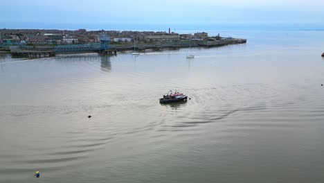 Pilot-boats-waiting-for-yachts-to-return-home-on-calm-water-at-dusk-on-the-River-Wyre-Estuary-Fleetwood-Lancashire-UK