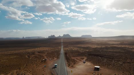Drone-view-along-famous-sunny-American-desert-highway-road-in-Monuments-Valley-in-Arizona-and-Utah,-Forrest-Gump-point-in-april