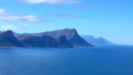 Cape-of-Good-Hope-Table-Mountain-coastline-costal-scenic-landscape-cliffside-view-South-Africa-Cape-Town-daytime-beauty-deep-blue-aqua-summertime-False-Bay-slow-pan-left-motion