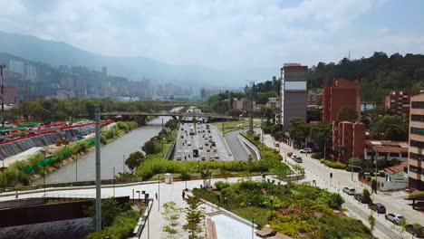 Stunning-slow-aerial-shot-of-busy-roads-and-streets-of-Medellin-in-summer