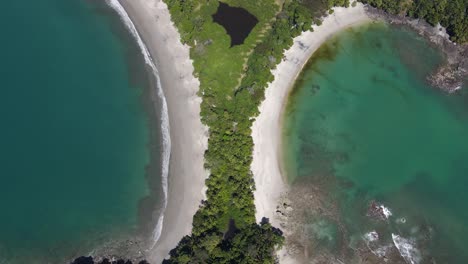 Slow-drone-shot-flying-away-from-Manuel-Antonio-National-Park,-Costa-Rica