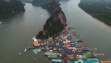 Aerial-view-tilting-over-the-Koh-Panyee-Floating-Fishing-Village,-in-cloudy-Thailand