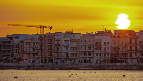 Iconic-township-of-Gzira-in-Malta-island-during-bright-sunset,-time-lapse-view