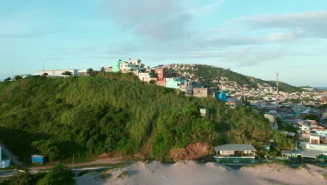 Small-Favela,-Humble-Houses-Built-in-Tropical-Hill-at-Arraial-do-Cabo,-Brazil-Seaside-Slums,-Aerial-Drone-Shot