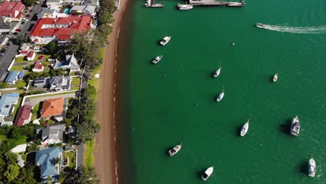 Boat-heading-Russell-pier,-aerial-birds-eye-view