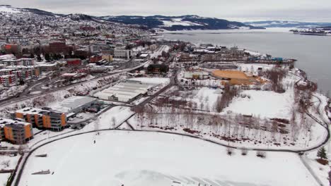 Student-city-Gjövik-in-Norway-in-approaching-drone-shot-on-cloudy-winter-day