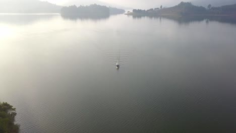 Serene-Nature-With-Boat-Sailing-On-Lake-Bunyonyi-During-Sunrise-In-Uganda,-Africa