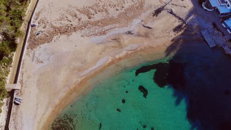Drone-entering-over-small-beach-on-Ibiza