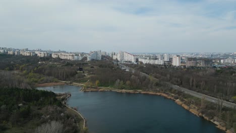 Chișinău-City-Gates-in-Moldova---Drone-flight-establishing-shot-in-spring-2023-with-lake-in-the-foreground---Chisinau-Bulevardul-Dacia---Aerial-4k-panorama-bird-view