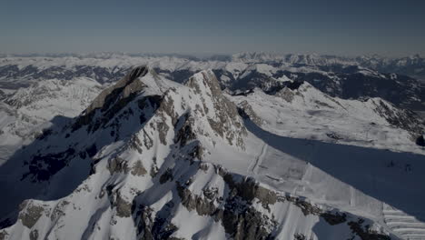 Aerial-orbiting-shot-of-snowy-Kitzsteinhorn-Mountain-lighting-by-sun-in-Austria