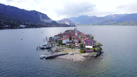 Aerial-dolly-in-towards-medieval-village-of-little-Isola-Superiore-in-biggest-lake-of-Italy