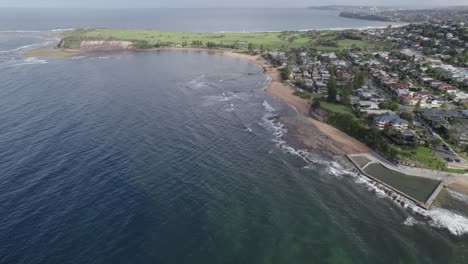 Fishermans-Beach-And-Ocean-Rockpool-In-Sydney,-NSW,-Australia---aerial-drone-shot