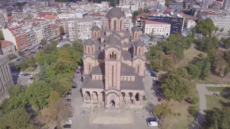 Slow-orbiting-4k-shot-of-St-Mark-Church-and-Tasmajdan-park-in-Serbia