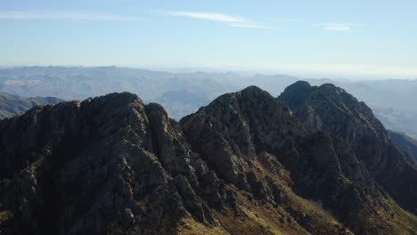 Aerial-view-around-the-rocky-Four-Peaks,-in-sunny-Mazatzal-Mountains,-Arizona,-USA