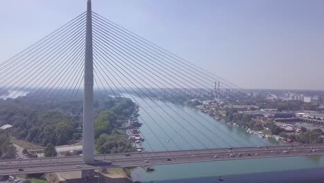 Orbiting-4k-aerial-shot-of-Ada-lake,-New-Belgrade-and-Ada-bridge