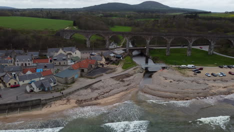 Discovering-the-beautiful-coastal-town-of-Cullen-in-Scotland-from-the-air,-with-its-beach-and-viaduct