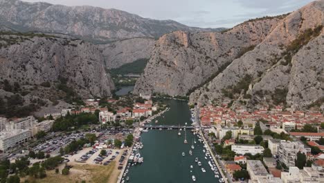 Cetina-River-mouth-in-Omis-town,-Croatia-winding-through-rugged-Dinara-Mountains-into-adriatic-sea