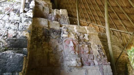 The-3-masks-on-the-right-hand-side-of-the-pyramid-of-the-Temple-of-the-Masks,-Mayan-site-at-Kohunlich---Quintana-Roo,-Mexico