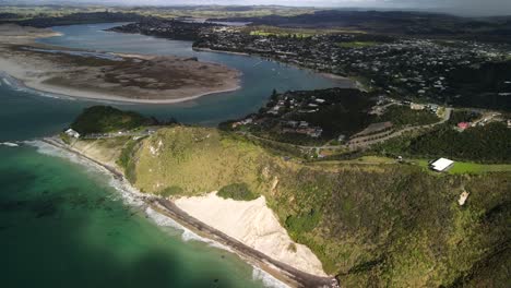Mangawhai-Heads-aerial-scenic-of-township-and-beachfront-in-popular-area,-Northland,-New-Zealand